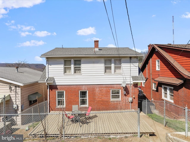 433 Williams St, Cumberland, MD 21502 - rear view of house featuring a fenced backyard, a chimney, brick siding, and roof with shingles