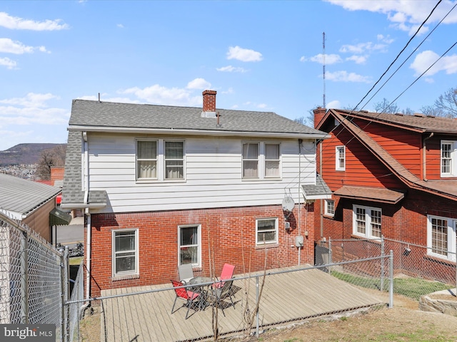 433 Williams St, Cumberland, MD 21502 - rear view of property featuring a fenced backyard, brick siding, roof with shingles, and a chimney