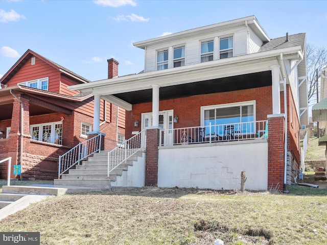 433 Williams St, Cumberland, MD 21502 - view of front facade with a chimney, a front lawn, a porch, and brick siding