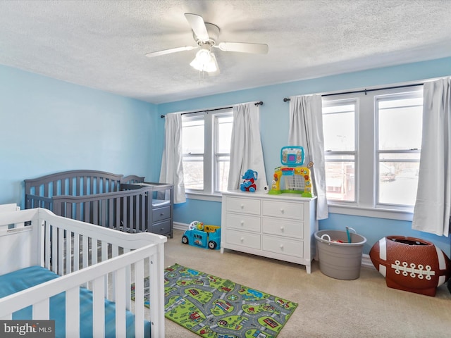 433 Williams St, Cumberland, MD 21502 - bedroom with a textured ceiling, a crib, baseboards, a ceiling fan, and carpet floors