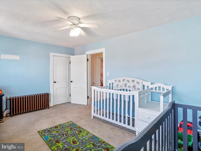 433 Williams St, Cumberland, MD 21502 - carpeted bedroom featuring a ceiling fan, radiator, and a textured ceiling