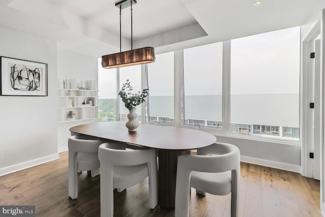 dining space with wood finished floors and baseboards
