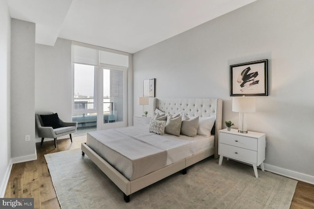 bedroom featuring wood finished floors and baseboards