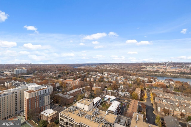 drone / aerial view featuring a city view and a water view