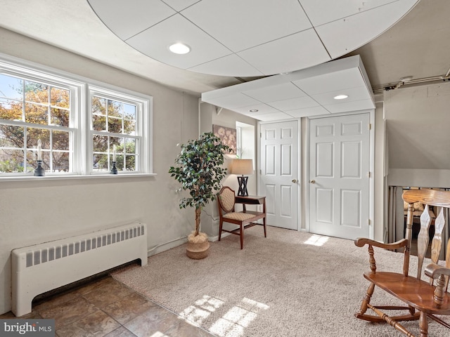 living area with carpet flooring and radiator heating unit