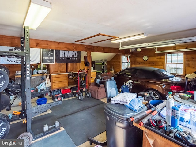 garage featuring wooden walls and a garage door opener