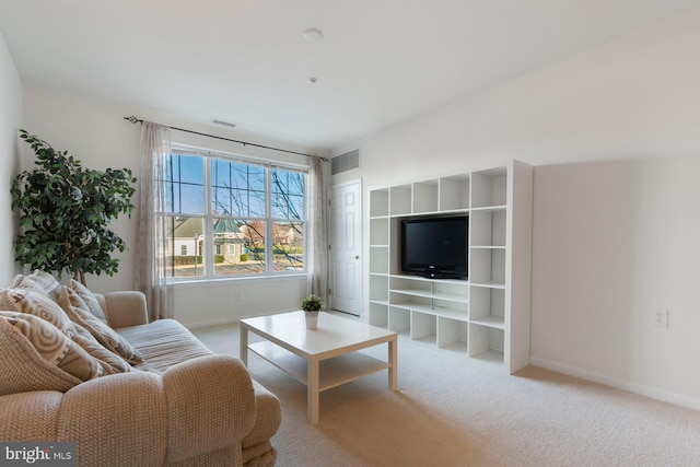 carpeted living area with baseboards and visible vents