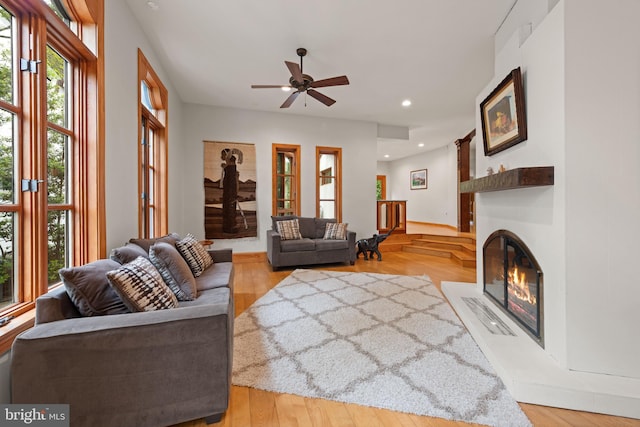 4544 30th St NW, Washington, DC 20008 - living room featuring wood finished floors, a ceiling fan, a glass covered fireplace, and recessed lighting