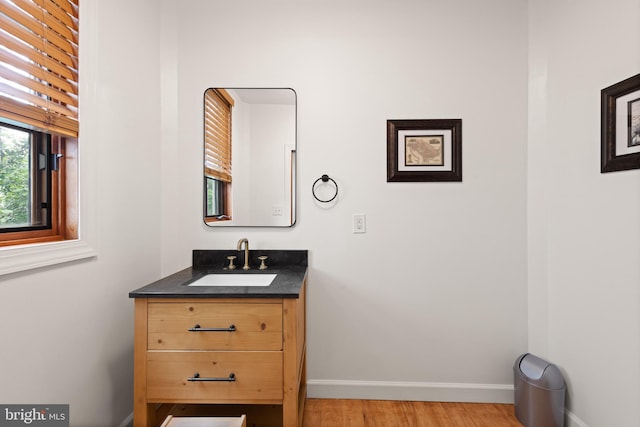 4544 30th St NW, Washington, DC 20008 - bathroom featuring baseboards, vanity, and wood finished floors
