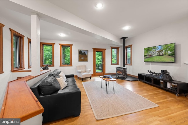 4544 30th St NW, Washington, DC 20008 - living room with a wood stove, light wood-style flooring, baseboards, and recessed lighting
