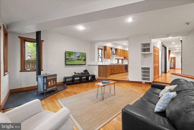 4544 30th St NW, Washington, DC 20008 - living room featuring baseboards, a wood stove, light wood finished floors, and beverage cooler