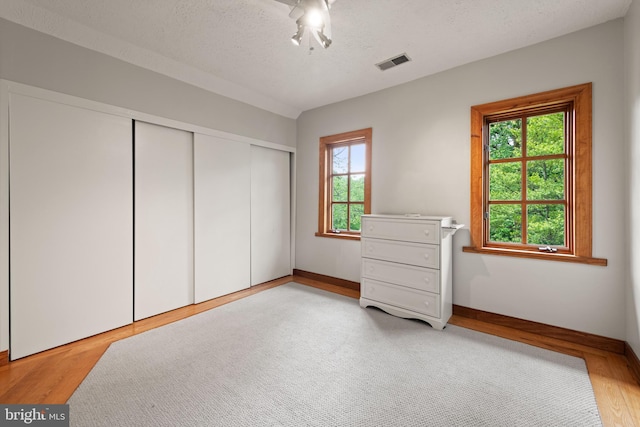 4544 30th St NW, Washington, DC 20008 - unfurnished bedroom featuring multiple windows, a closet, light wood-style flooring, and visible vents