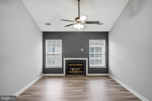 11575 Cavalier Landing Ct Unit 402, Fairfax, VA 22030 - unfurnished living room with wood finished floors, baseboards, a ceiling fan, and a glass covered fireplace