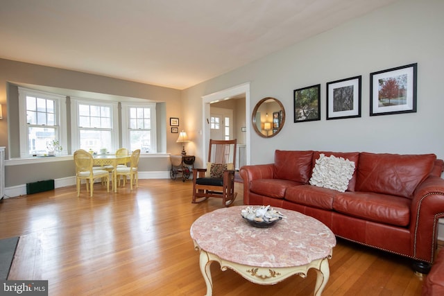 living room with light wood-style flooring and baseboards
