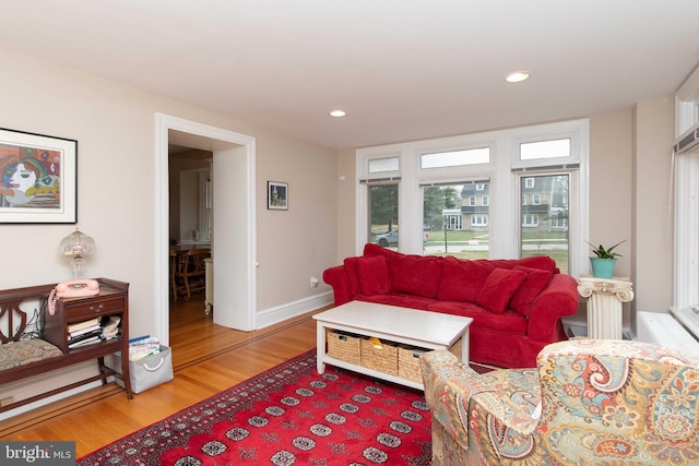 living room featuring light wood finished floors, recessed lighting, and baseboards