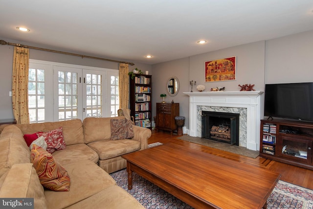 living area featuring a fireplace, recessed lighting, and wood finished floors