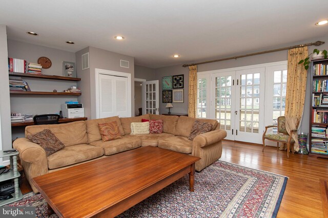 living room with french doors, wood finished floors, and recessed lighting