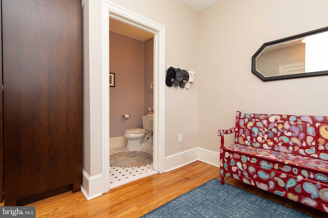bathroom featuring wood finished floors, toilet, and baseboards