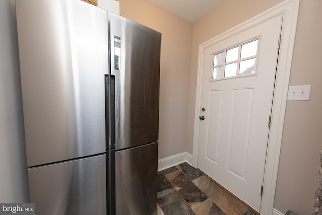 kitchen with freestanding refrigerator and baseboards