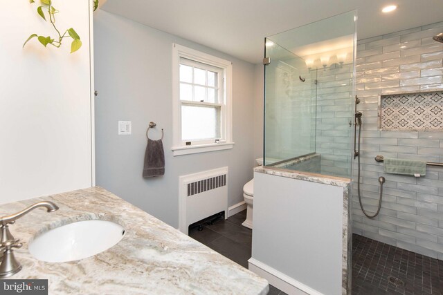 full bathroom with radiator heating unit, walk in shower, toilet, baseboards, and recessed lighting