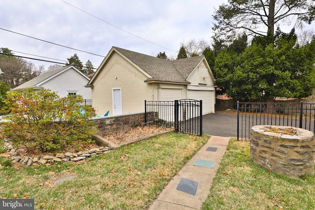 view of side of property featuring fence, stucco siding, roof with shingles, and an outbuilding