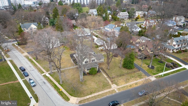 aerial view of property and surrounding area featuring nearby suburban area