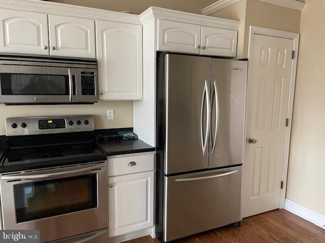 125 Hillview Rd, Kunkletown, PA 18058 - kitchen featuring stainless steel appliances, dark countertops, dark wood-type flooring, and white cabinetry