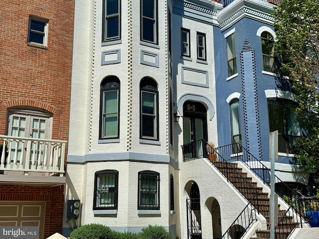 townhome / multi-family property featuring stairway and brick siding