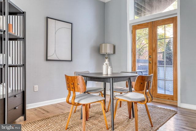 dining area with wood finished floors and baseboards
