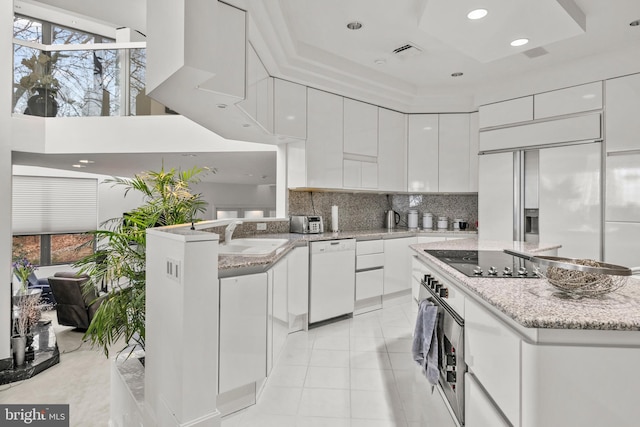 910 Pennwood Cir, Lancaster, PA 17601 - kitchen with white dishwasher, modern cabinets, black electric stovetop, a sink, and white cabinets