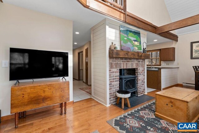 145 Firtree Dr, Wintergreen Resort, VA 22967 - living room with light wood-type flooring, recessed lighting, a baseboard radiator, baseboards, and a wood stove