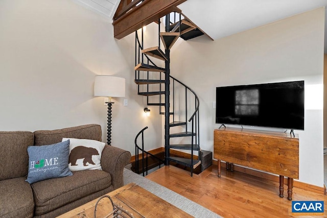 145 Firtree Dr, Wintergreen Resort, VA 22967 - living area featuring lofted ceiling with beams, wood finished floors, and stairs