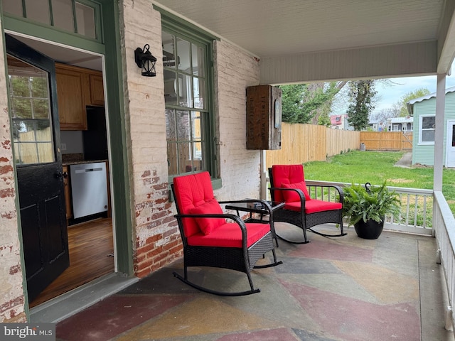 view of patio / terrace featuring fence and covered porch