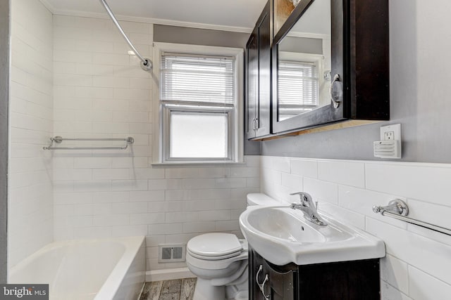 bathroom with vanity, visible vents, ornamental molding, tile walls, and toilet