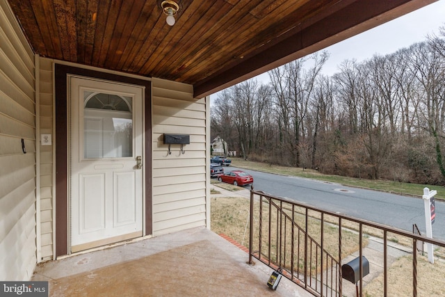view of exterior entry featuring a porch