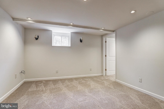 below grade area with recessed lighting, light colored carpet, and baseboards