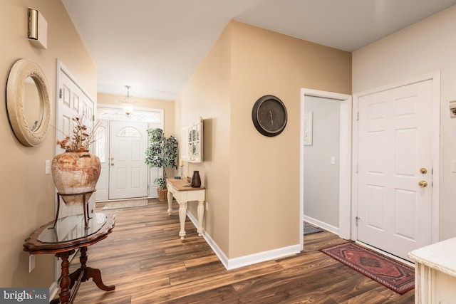 entryway featuring baseboards and dark wood-style flooring