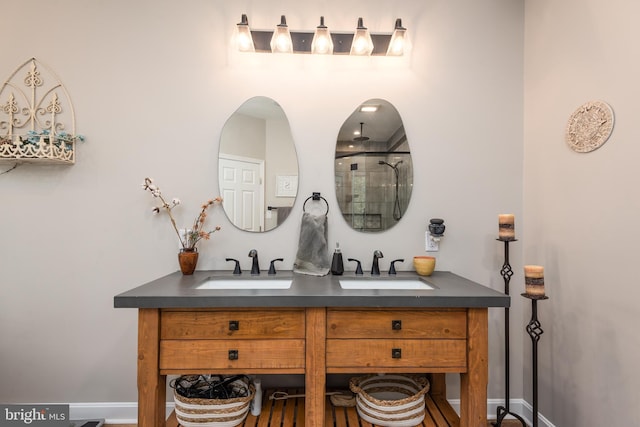 bathroom featuring double vanity, a shower, and a sink