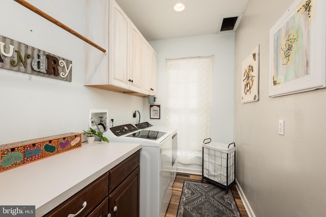 laundry area with baseboards, visible vents, cabinet space, dark wood-style flooring, and washer and clothes dryer