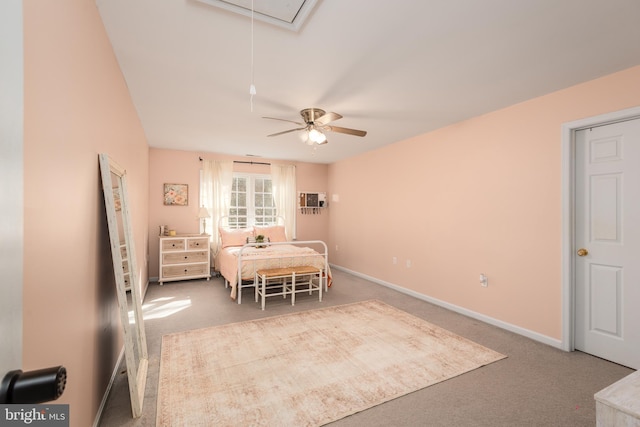 carpeted dining space featuring attic access, baseboards, and ceiling fan