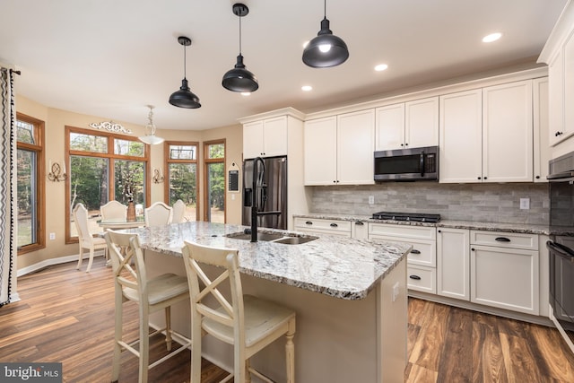 kitchen with decorative backsplash, dark wood-style flooring, white cabinetry, and appliances with stainless steel finishes