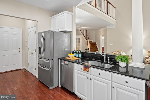 8725 Warm Waves Way Unit 10, Columbia, MD 21045 - kitchen featuring a sink, appliances with stainless steel finishes, dark wood-style floors, dark stone countertops, and white cabinetry