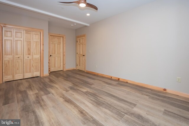 unfurnished bedroom with wood finished floors, baseboards, recessed lighting, a closet, and ceiling fan