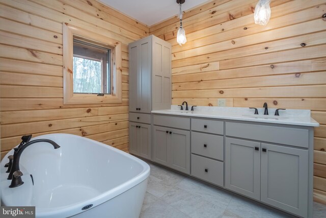 bathroom featuring wood walls, a freestanding tub, and double vanity