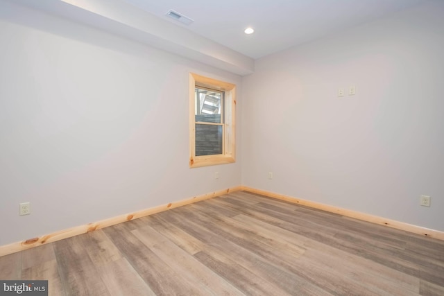 spare room featuring baseboards, wood finished floors, and recessed lighting