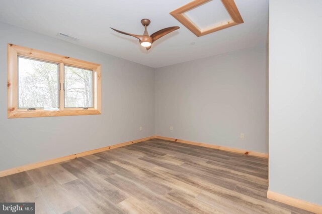 unfurnished room featuring baseboards, wood finished floors, and a ceiling fan
