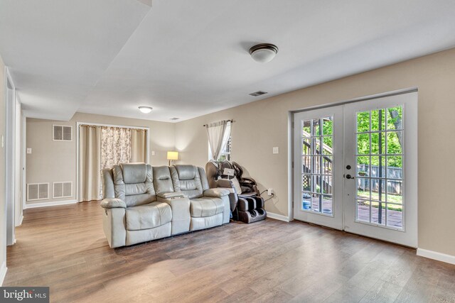 4735 Queens Grove St, White Plains, MD 20695 - living area with visible vents, wood finished floors, and a healthy amount of sunlight