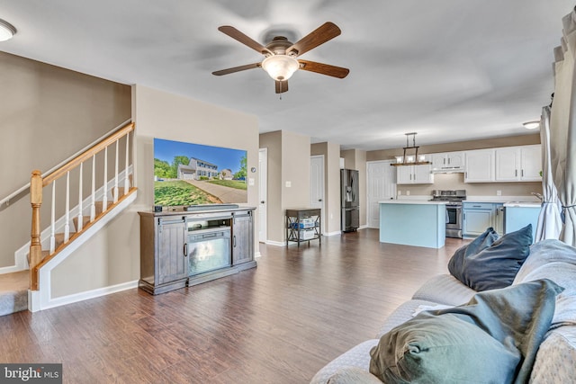 4735 Queens Grove St, White Plains, MD 20695 - living room featuring baseboards, ceiling fan with notable chandelier, dark wood-style floors, and stairs