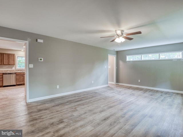 836 Woodsmill Rd, Stephenson, VA 22656 - empty room with baseboards, ceiling fan, a sink, and light wood-style flooring