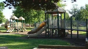 community jungle gym with a yard